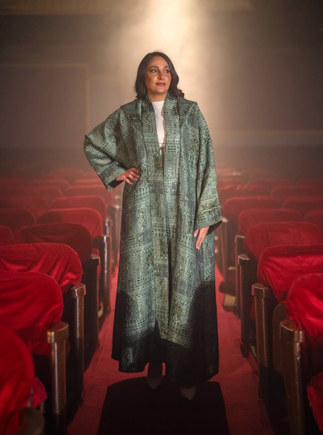 Green brocade abaya in theatre setting