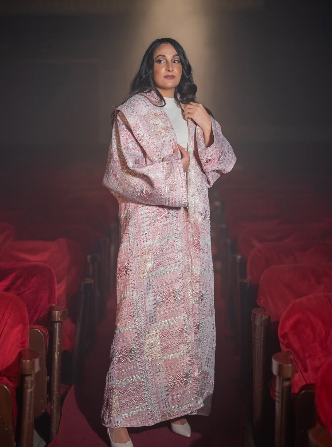 Pink embroidered Jacquard Brocade Abaya in theatre setting