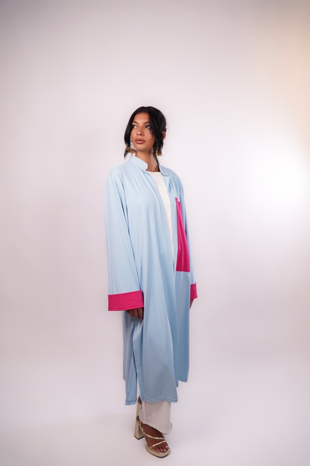 Hydrangea open-front robe in pale blue with fuchsia cuffs, standing, full length, from the Le Kanz summer collection