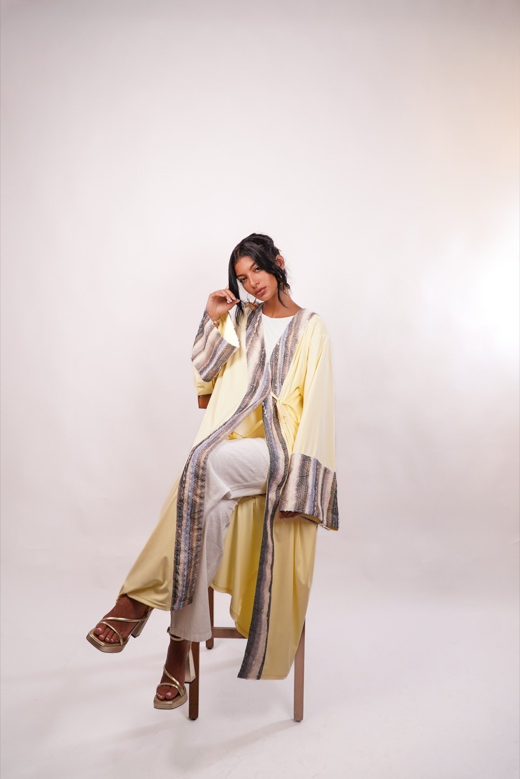 Desert Dunes open-front robe in pale yellow with a striped panel, standing, full length, from the Le Kanz summer collection