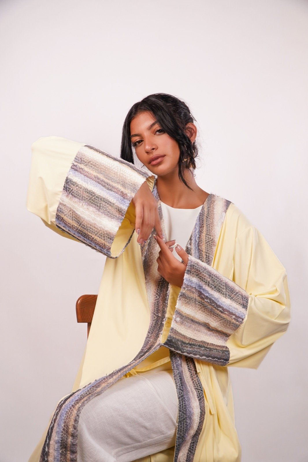 Desert Dunes open-front robe in pale yellow with a striped panel, arm raised to show the sleeve, from the Le Kanz summer collection