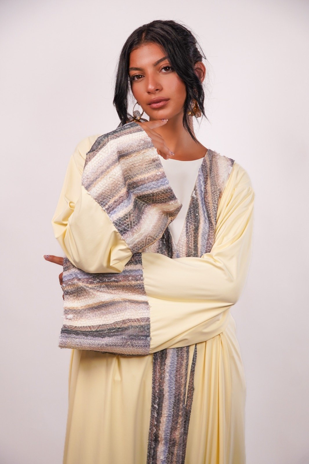 Desert Dunes open-front robe in pale yellow with a striped panel, waist-up, arms crossed, from the Le Kanz summer collection