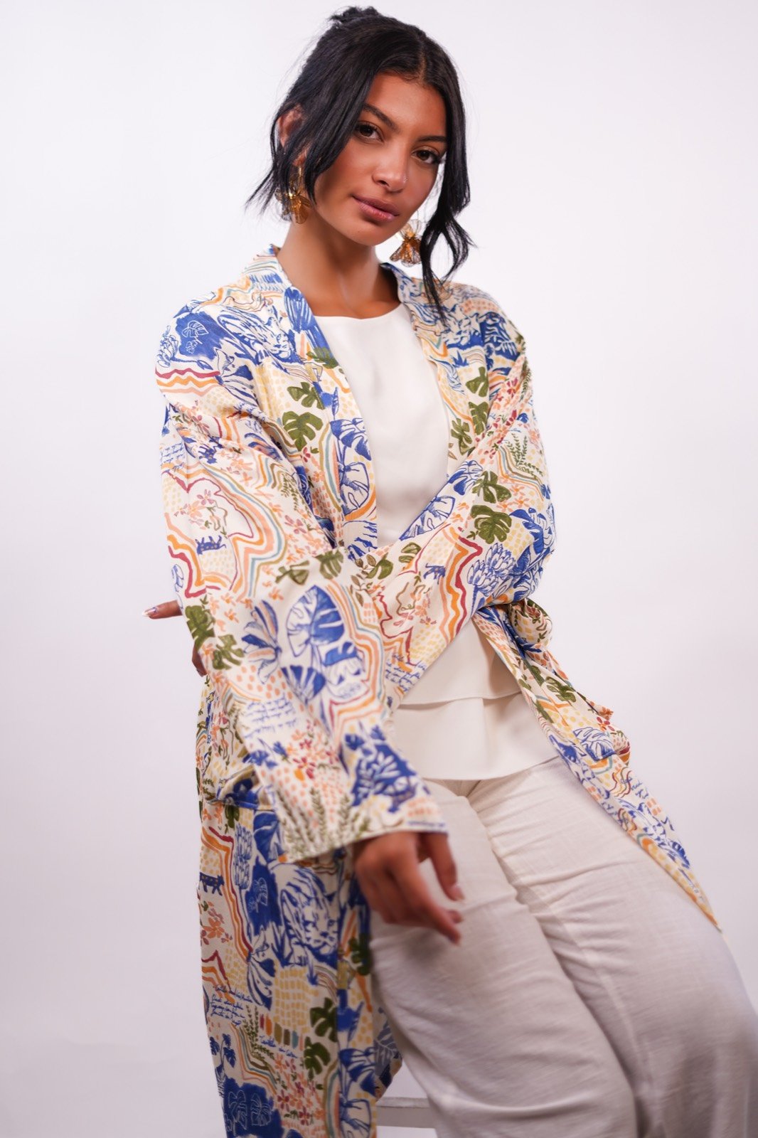 Azure Eden open-front robe in cream with blue floral print, standing, hand on hip, from the Le Kanz summer collection