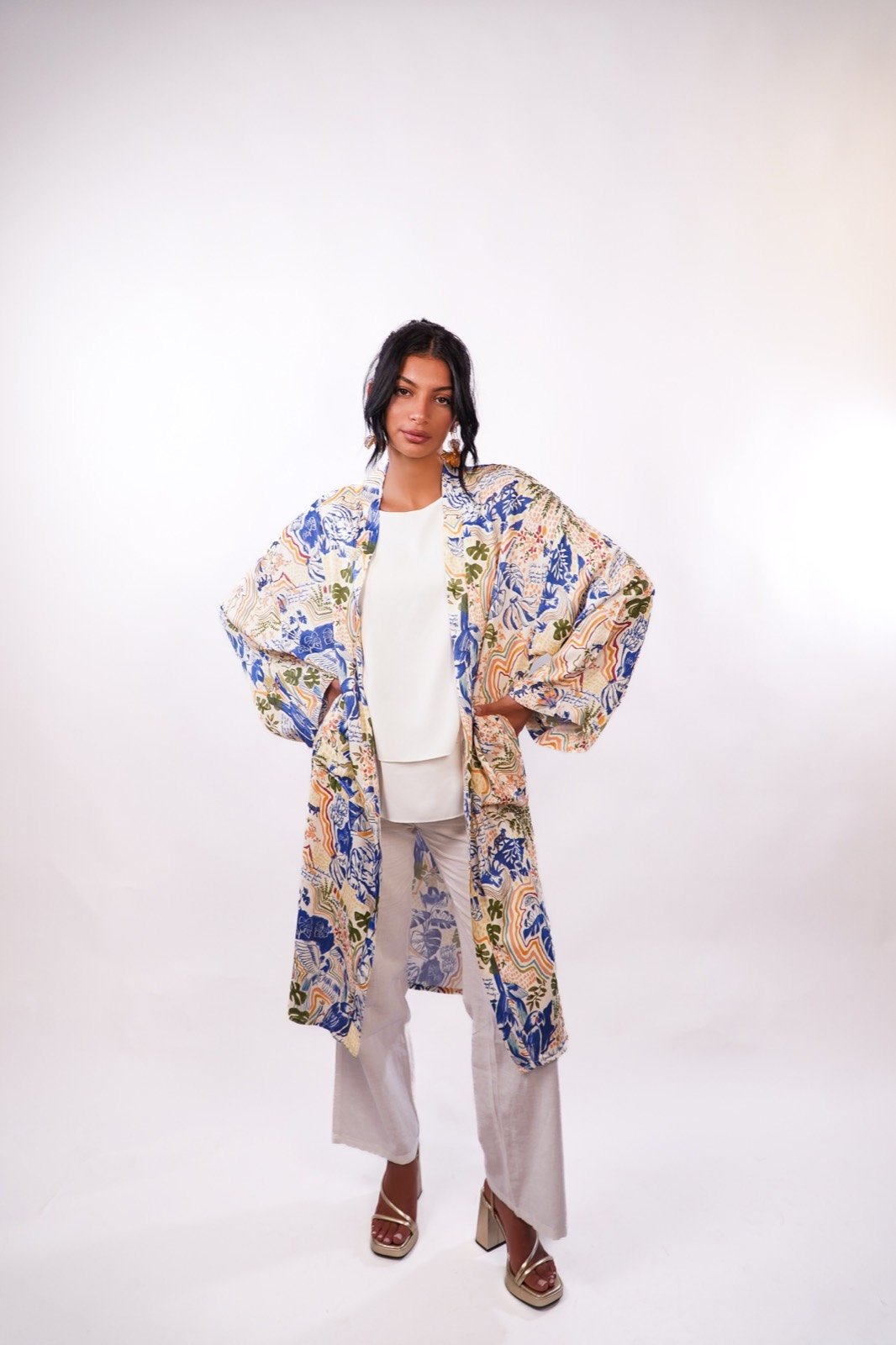 Azure Eden open-front robe in cream with blue floral print, sleeves held wide, from the Le Kanz summer collection