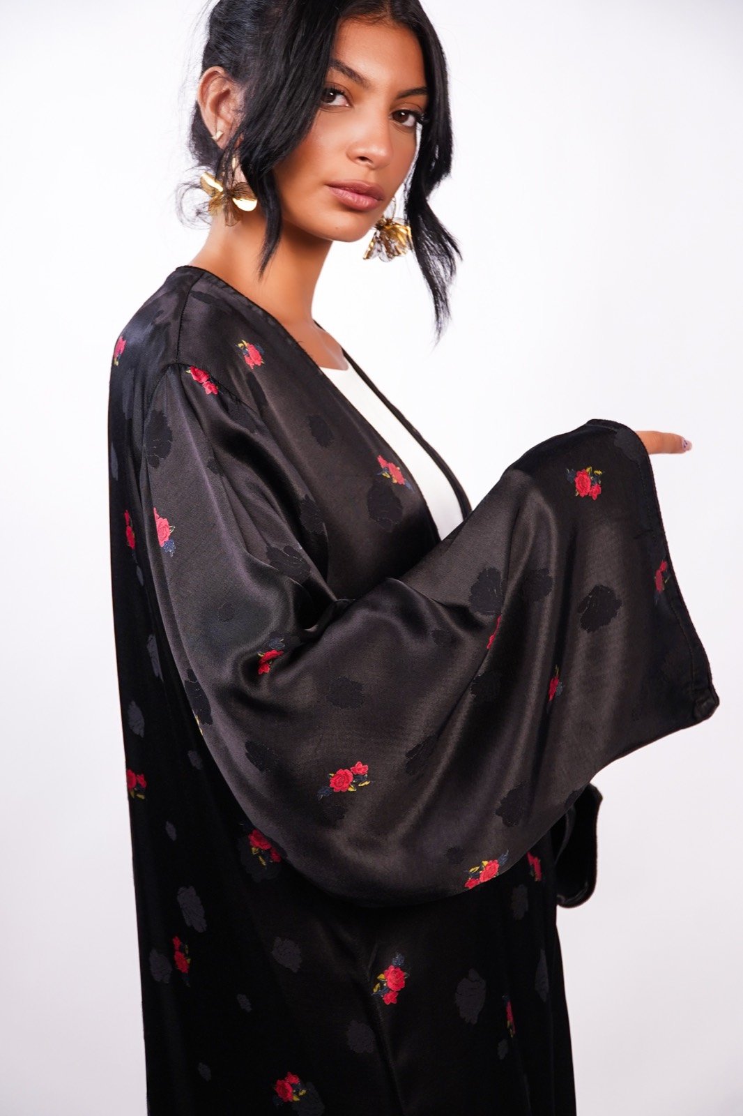 Scarlet Whisper open-front robe in black with small red flowers, sleeves outstretched, from the Le Kanz summer collection