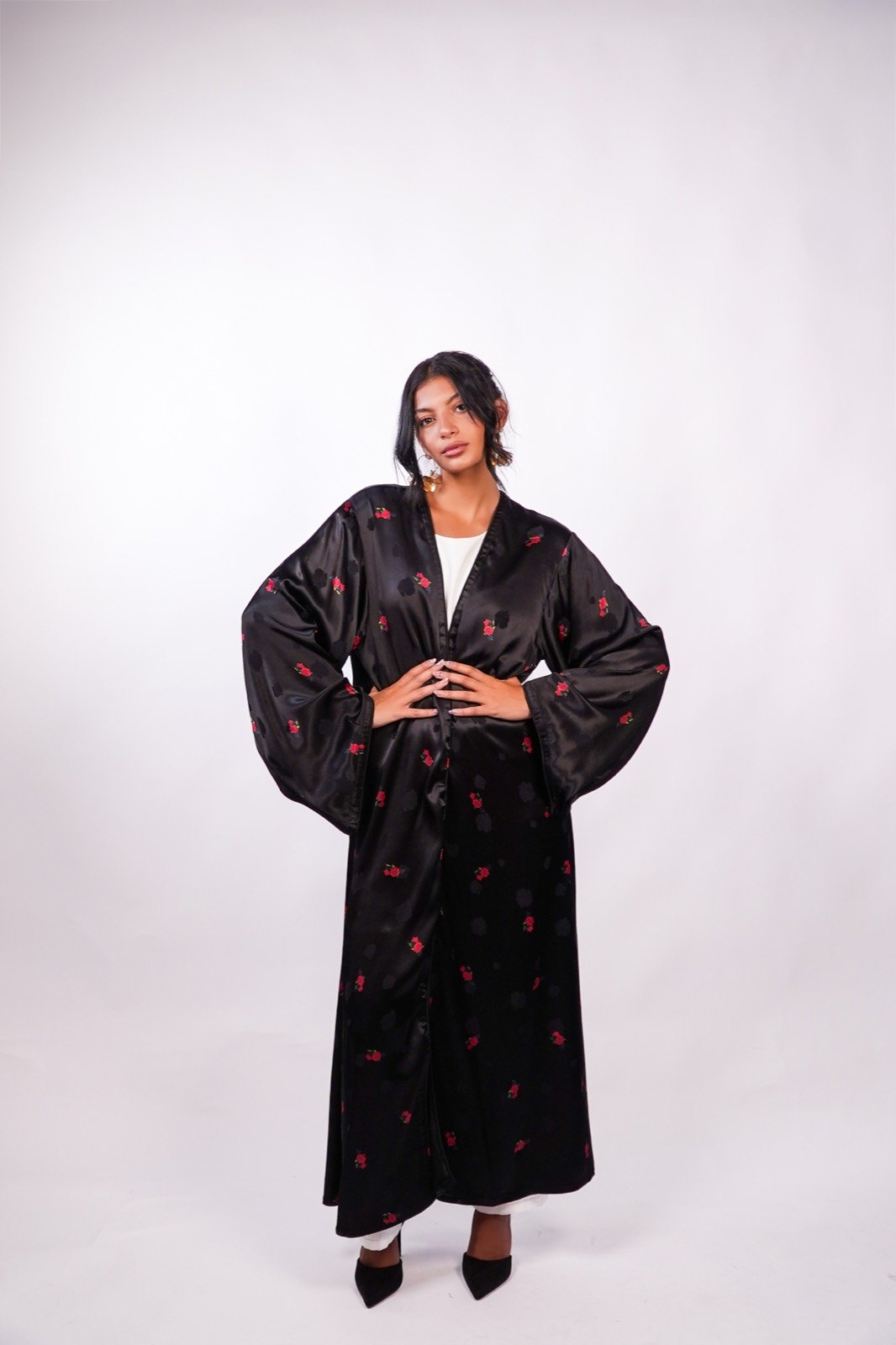 Scarlet Whisper open-front robe in black with small red flowers, standing, full length, from the Le Kanz summer collection